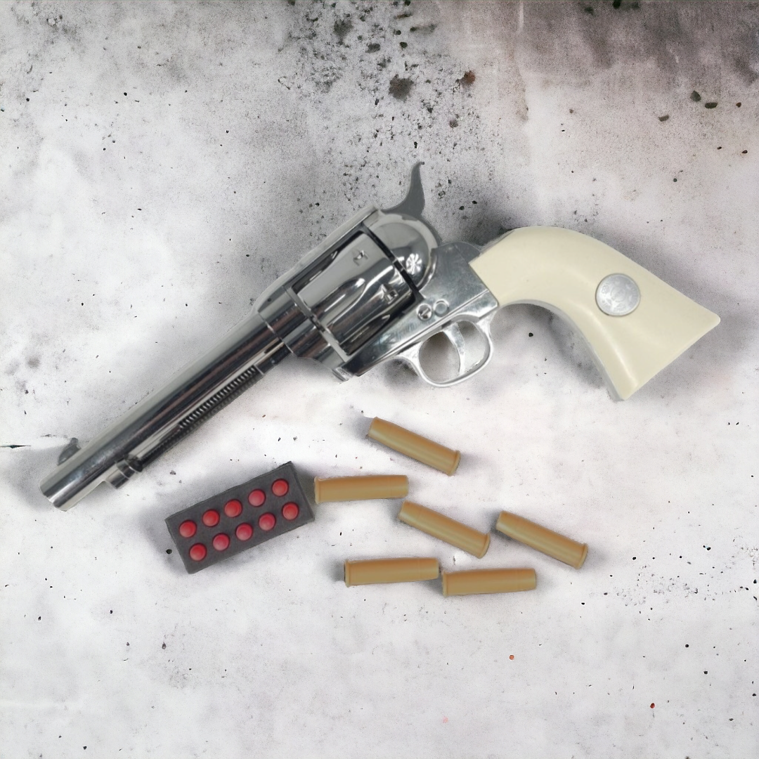 KELe Colt 1873 Peacemaker revolver in silver with white handle and ammunition.