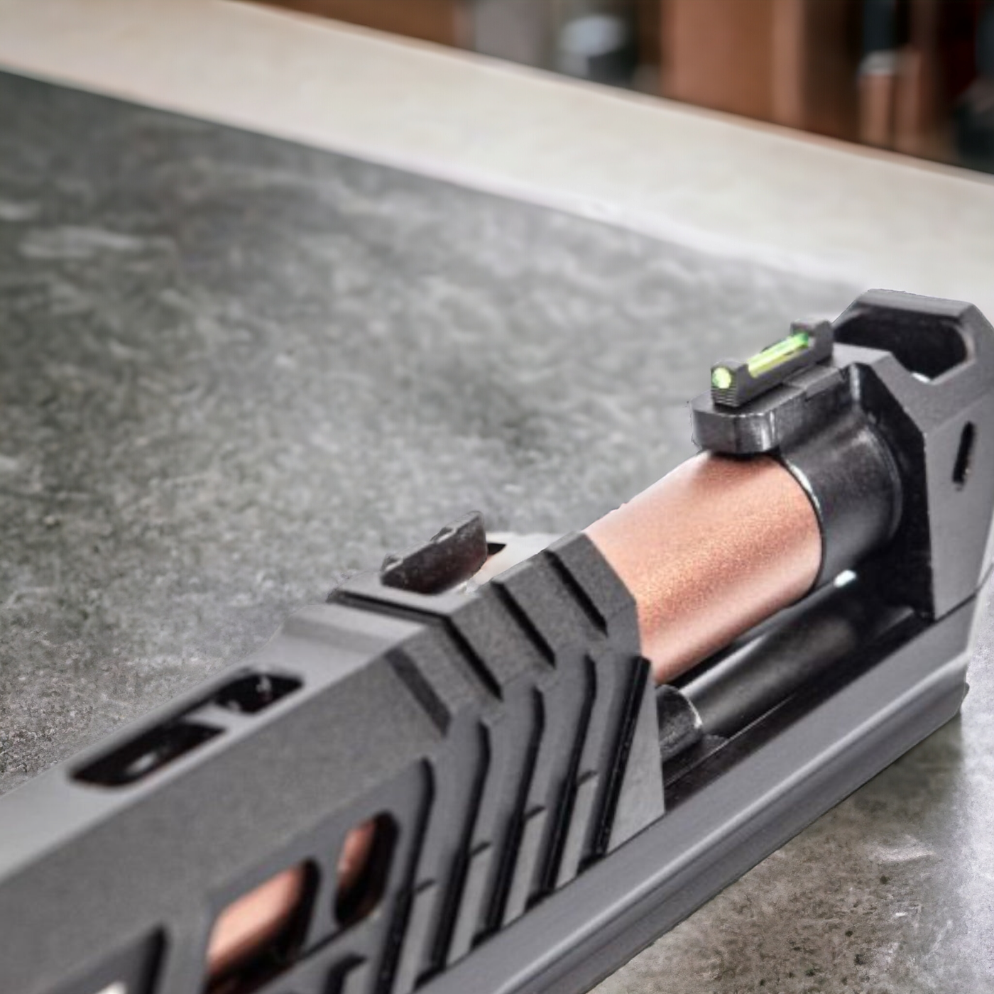 Close-up of the Golden Eagle TTI Pit Viper blowback gel blaster's slide featuring copper barrel and green fiber optic sight.