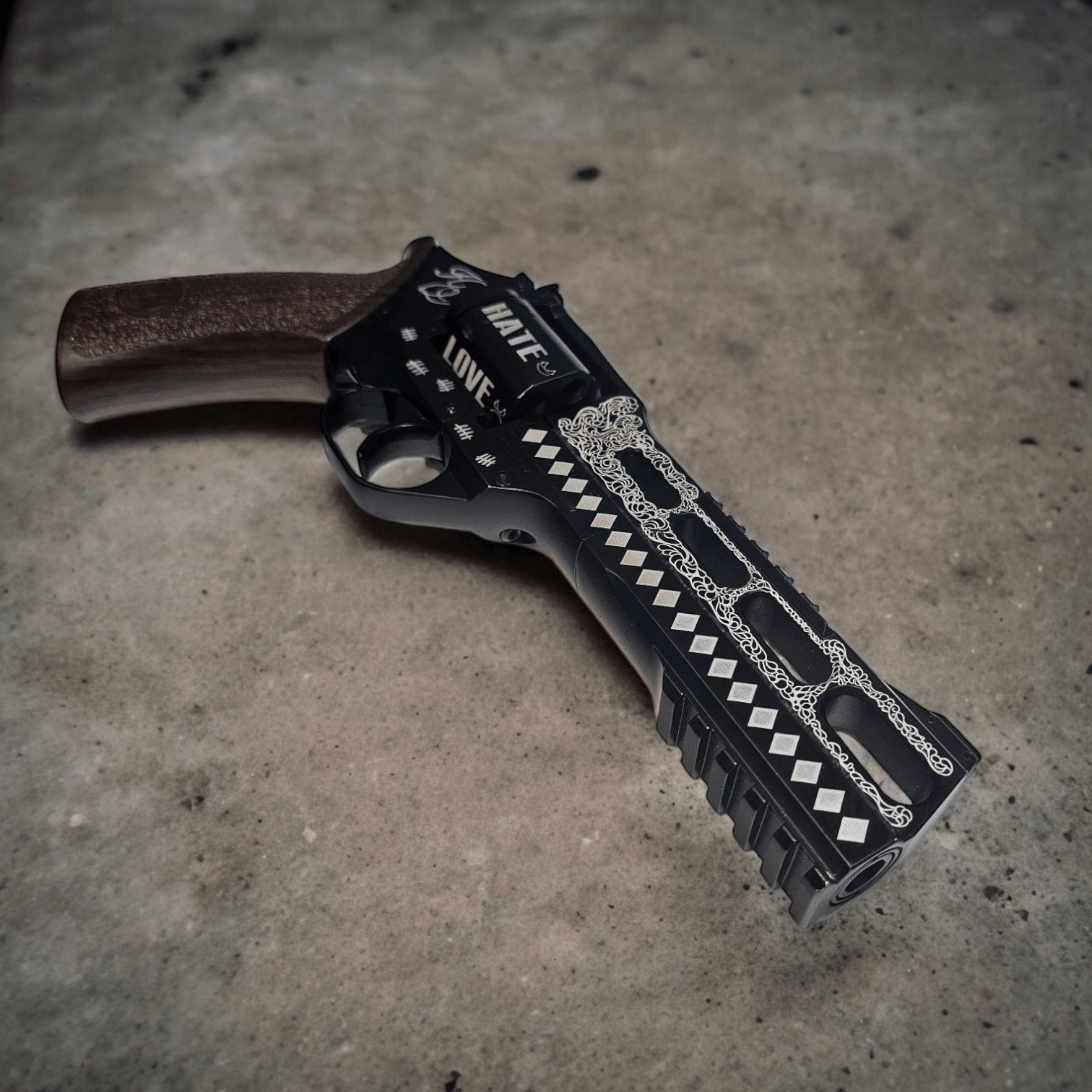 Harley Quinn Chiappa Rhino revolver with intricate laser etching and wooden grip.