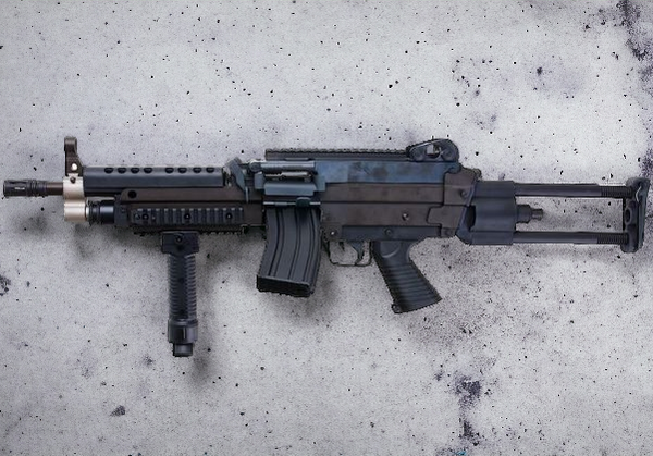 A&K Cybergun FN Licensed M249K MINIMI SAW full metal gel blaster AEG machine gun on textured surface.