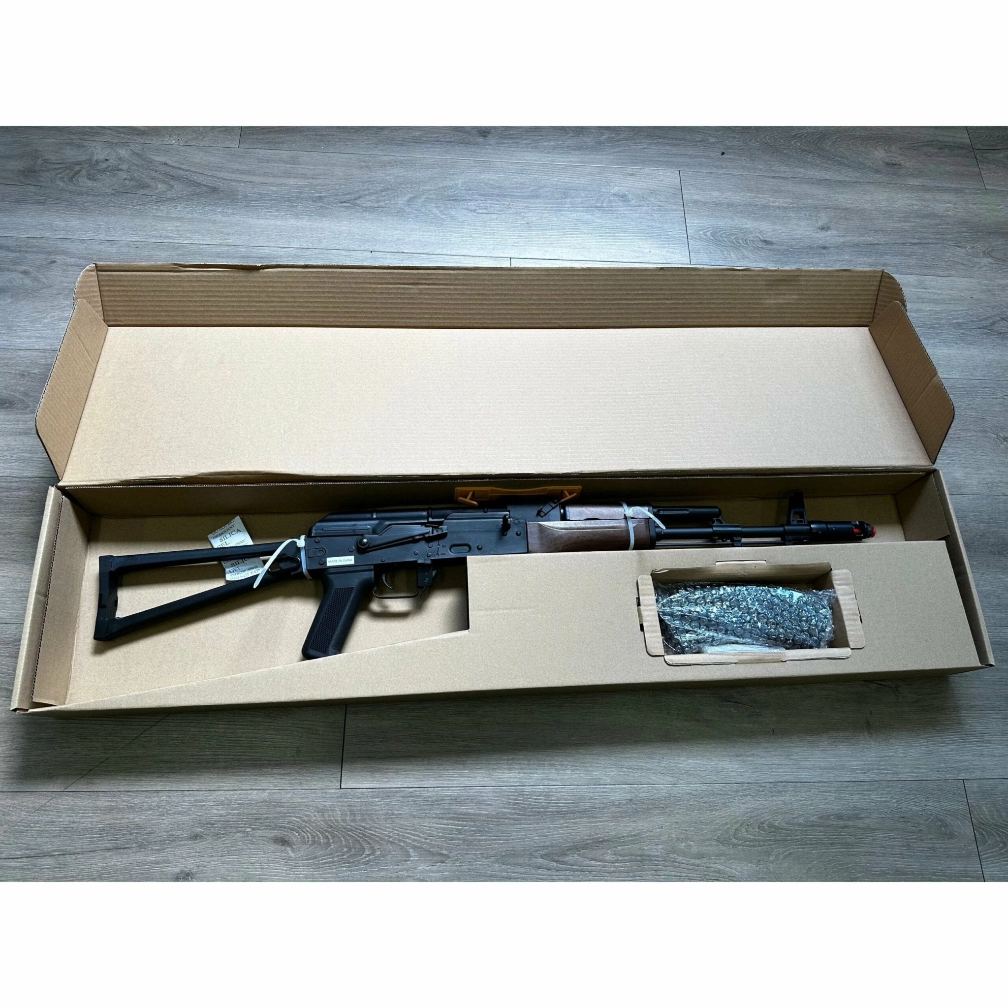 DOUBLE BELL BYP-02B AKS-74N airsoft gun in box, showcasing automatic features and metal construction.