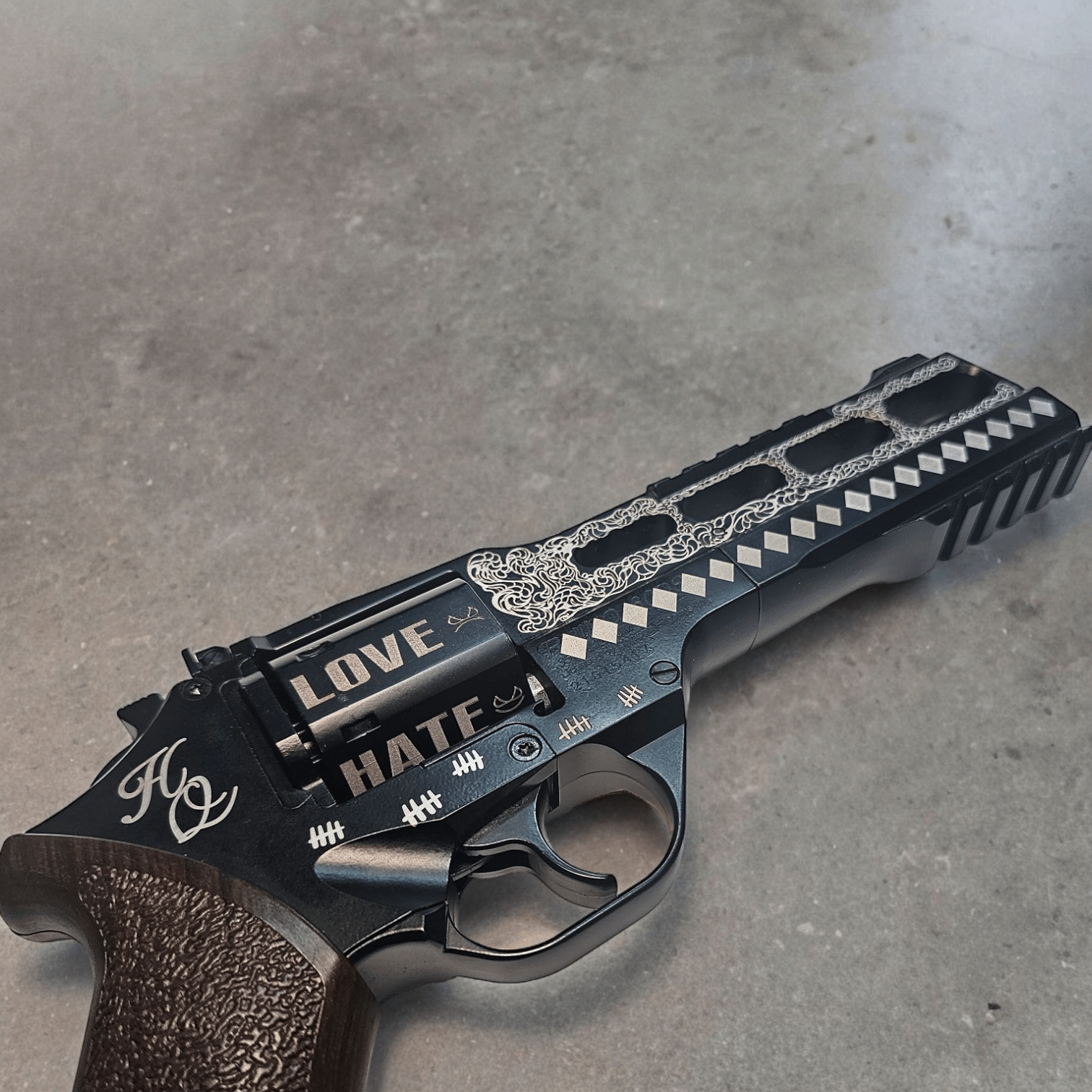 Custom Harley Quinn Chiappa Rhino revolver with laser etching, featuring 'LOVE' and 'HATE' inscriptions.