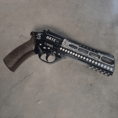 Customized Harley Quinn Chiappa Rhino revolver with laser etching showing 'HATE' and 'LOVE' on the barrel.